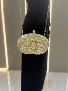 Detailed macro view of the sparkling yellow rhinestones and gold metal chain strap