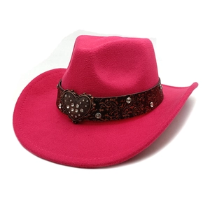 Detail of rose red felt cowboy hat featuring a leather band with rhinestone heart buckle