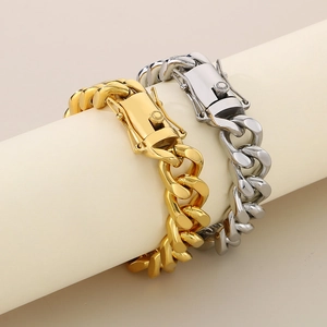 Close-up of 13mm gold and silver Cuban link bracelets with box clasps on a stand