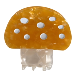 Pince à cheveux mignonne en acétate en forme de champignon jaune à pois blancs sur fond blanc