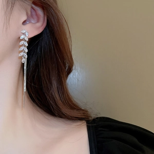 Detailed view of silver wheat ear tassel earrings with shimmering cubic zirconia