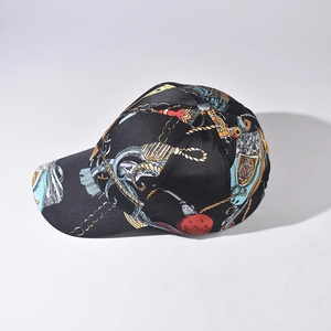 Black baseball cap with gold chain and heraldic print featuring a curved brim style