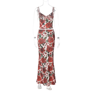 Detailed view of white two-piece set with red rose print V-neck top and fishtail maxi skirt