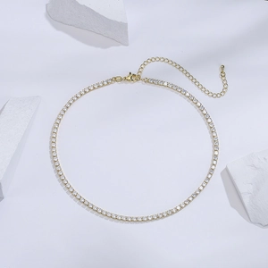18K gold-plated necklace with sparkling zirconia pendants on a white minimalist background
