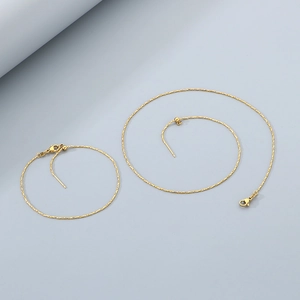 Macro detail of adjustable 18K gold-plated titanium steel necklaces with lobster clasps