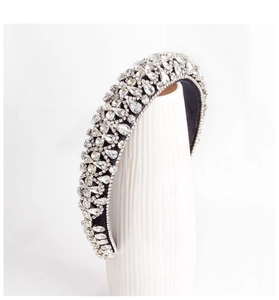 Macro shot of silver rhinestones on a black sponge headband with sparkling crystals