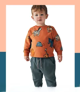 Detail of child wearing a long-sleeved sweatshirt with colorful animal prints and ribbed cuffs