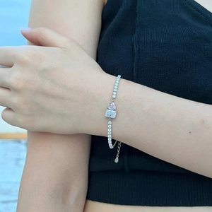 Detail of S925 silver tennis bracelet with pink heart stone and zircon on wrist