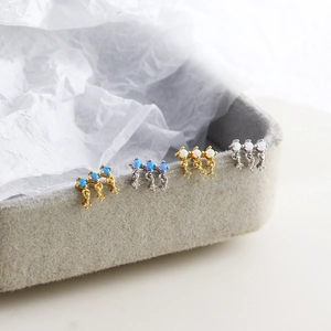 Detailed view of S925 silver stud earrings with blue opal stones in gold and silver finishes