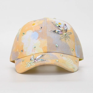 Detail of colorful tie-dye kids baseball cap with sparkling butterfly rhinestone pattern