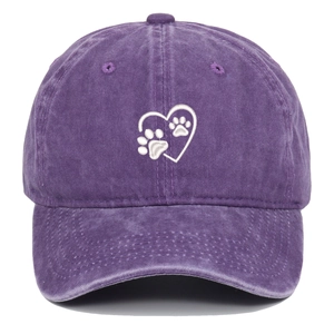 Detail of washed purple cotton baseball cap featuring white heart and paw print embroidery