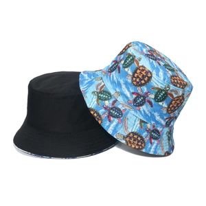 Reversible bucket hat with turtle print and solid black design for sun protection