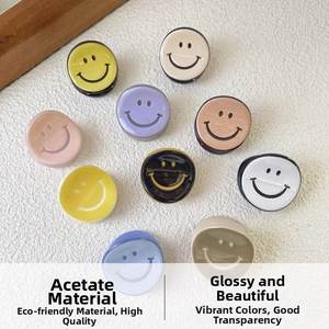 Detailed close-up of colorful acetate mini hair clips with classic smiley face patterns