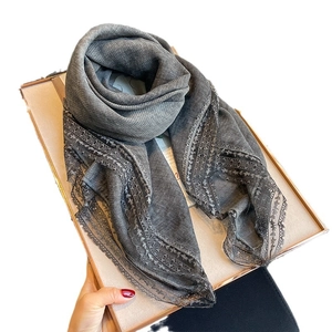 Elegant linen-cotton scarf in grey with delicate lace trim, presented on a gift box