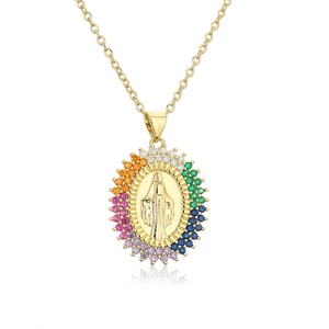 Macro shot of gold-plated Virgin Mary pendant featuring a colorful zircon halo on o-chain