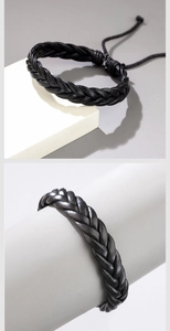 Detail view of black braided leather bracelet with adjustable drawstring and fine texture