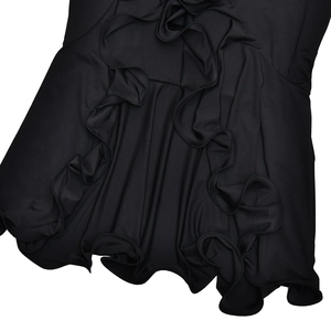 Detail view of layered black ruffles and pleats on long sleeve maxi dress fabric