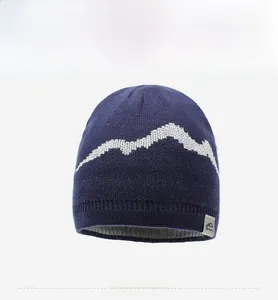 Detailed front view of navy knit beanie featuring white mountain pattern and grey lining