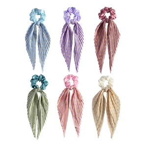 Set of 6 pleated silk scrunchies with long ribbons and golden polka dots on white background