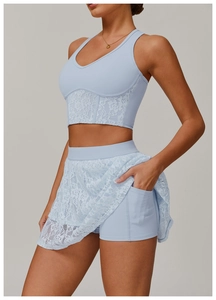 Close-up of light blue yoga skort showing lace details and functional side phone pocket