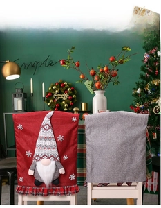 Detail of Christmas chair covers featuring 3D gnome motifs and rustic burlap texture