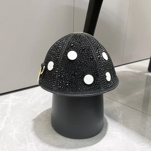 Detailed view of mushroom-shaped evening bag featuring black and white rhinestone studs