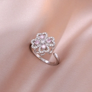 Macro detail of silver adjustable clover ring with pink and white cubic zirconia