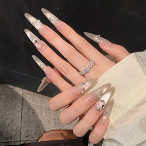 Cat-eye stiletto press-on nails with pearls, crystals, and metallic chain accents
