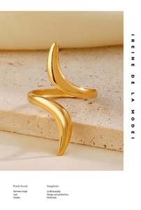 Detail of 18K gold plated S-shaped adjustable ring on natural stone texture display