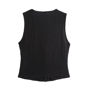 Detail shot of the black sleeveless top featuring a rich pleated textured fabric surface