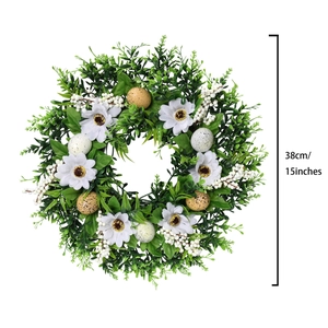 Detailed view of a 38cm Easter wreath with green leaves, white flowers and speckled eggs