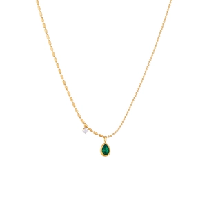 Gold chain necklace featuring asymmetric beads and a large green teardrop pendant charm
