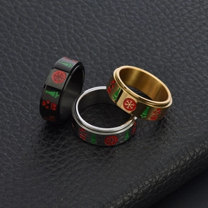 Rotating stainless steel Christmas rings with engraved tree and star patterns in three colors