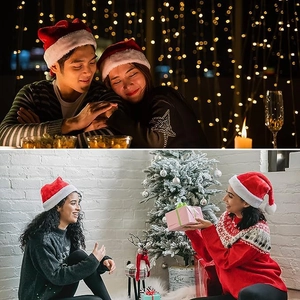 Atmospheric lifestyle scene of people wearing red plush Christmas hats by the festive tree