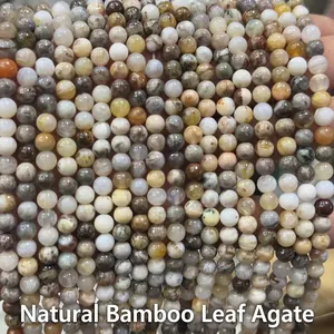 Macro detail of natural bamboo leaf agate round beads with unique organic textures