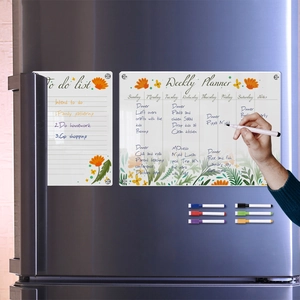 Macro view of magnetic acrylic weekly planner and to-do list set on a stainless fridge