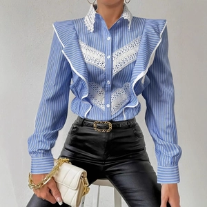 Close-up of blue striped shirt featuring white lace trim and ruffle collar detail