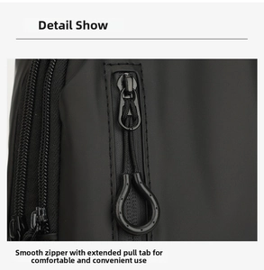 Detail display of smooth zipper and long loop puller on black waterproof chest bag