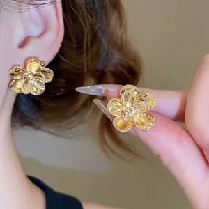 Elegant gold flower stud earrings for women featuring 3D layered metallic petal design