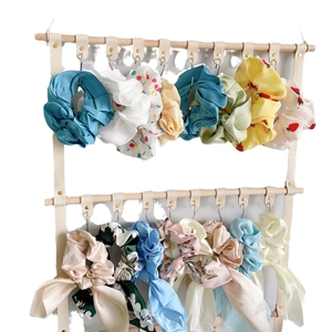 DIY PU leather hair accessory wall organizer displaying colorful bows and headbands