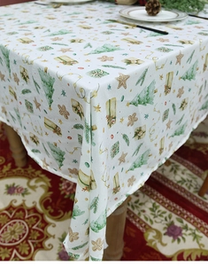 Detail of Christmas tablecloth featuring festive patterns like pine trees and gingerbread men