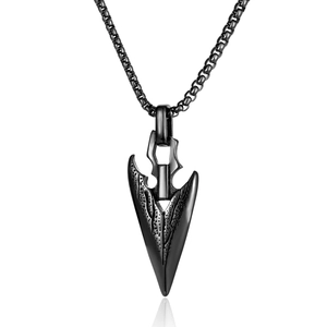 Detailed view of black metal arrowhead pendant with textured surface on a matching chain