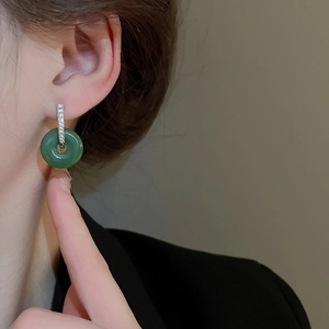 Elegant Chinese jade pingan buckle earrings with diamonds on a female model