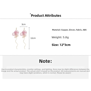 Detail showing pink fabric flower earrings with long gold tassels and cubic zirconia accents