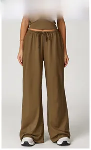Detail of coffee brown wide leg pants featuring high waist drawstring and soft fabric