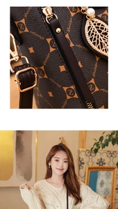 Detail of brown monogram handbag with gold leaf pendant and pearl charm on leather