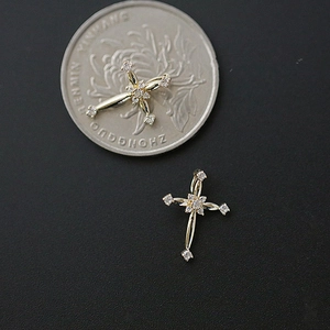 French style S925 silver gold cross earrings with clear stones displayed on a coin