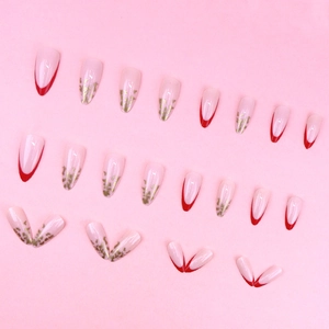 French tip press-on nails with gold foil accents and almond shape in a 24-piece set