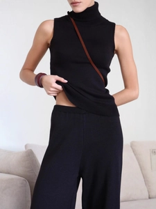 Women's black knit set featuring a high-neck sleeveless top and high-waist wide-leg pants
