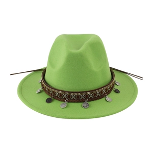 Close-up showing the ethnic woven band and silver coin charms on green wool fedora hat